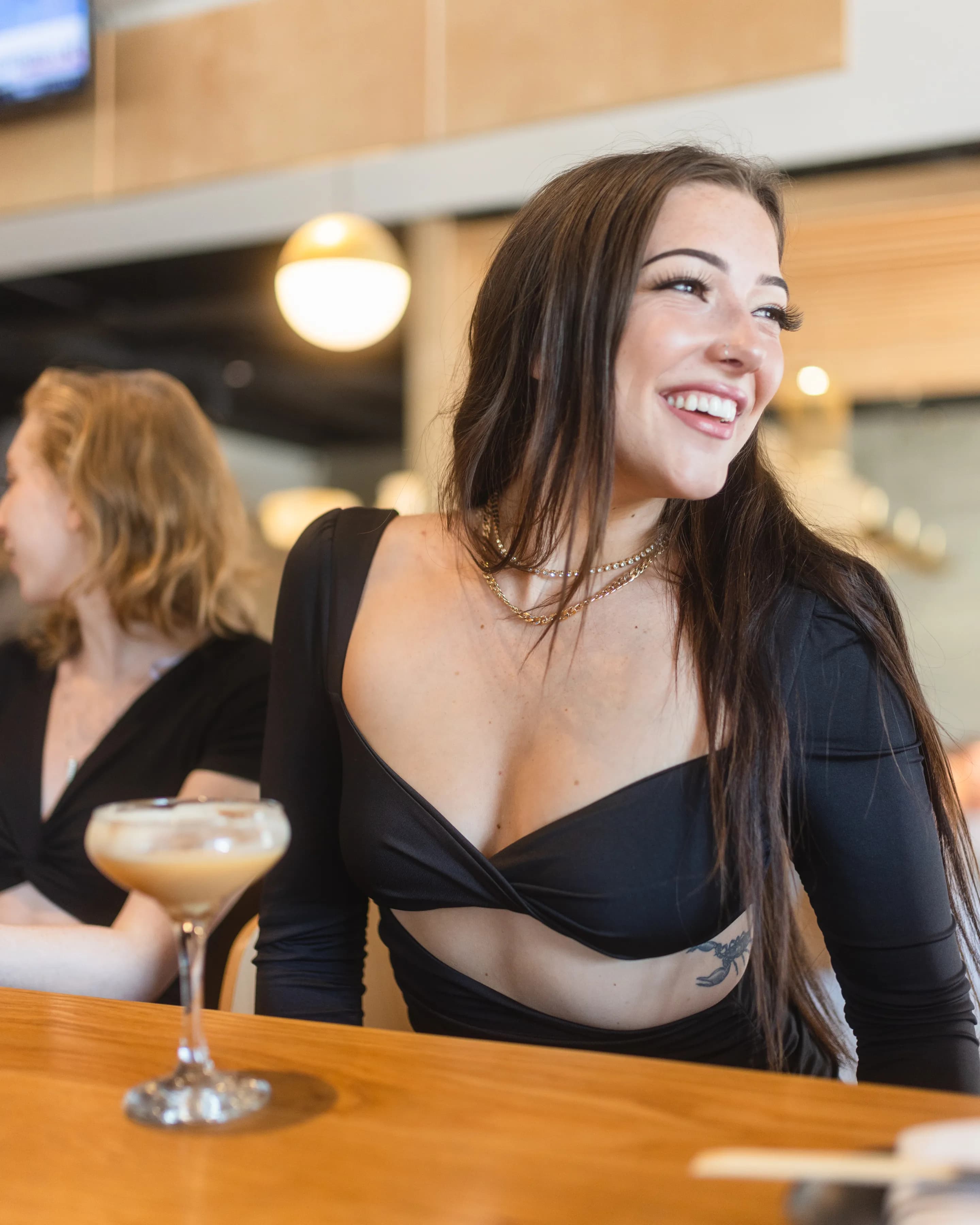 Guest laughing at a cocktail bar