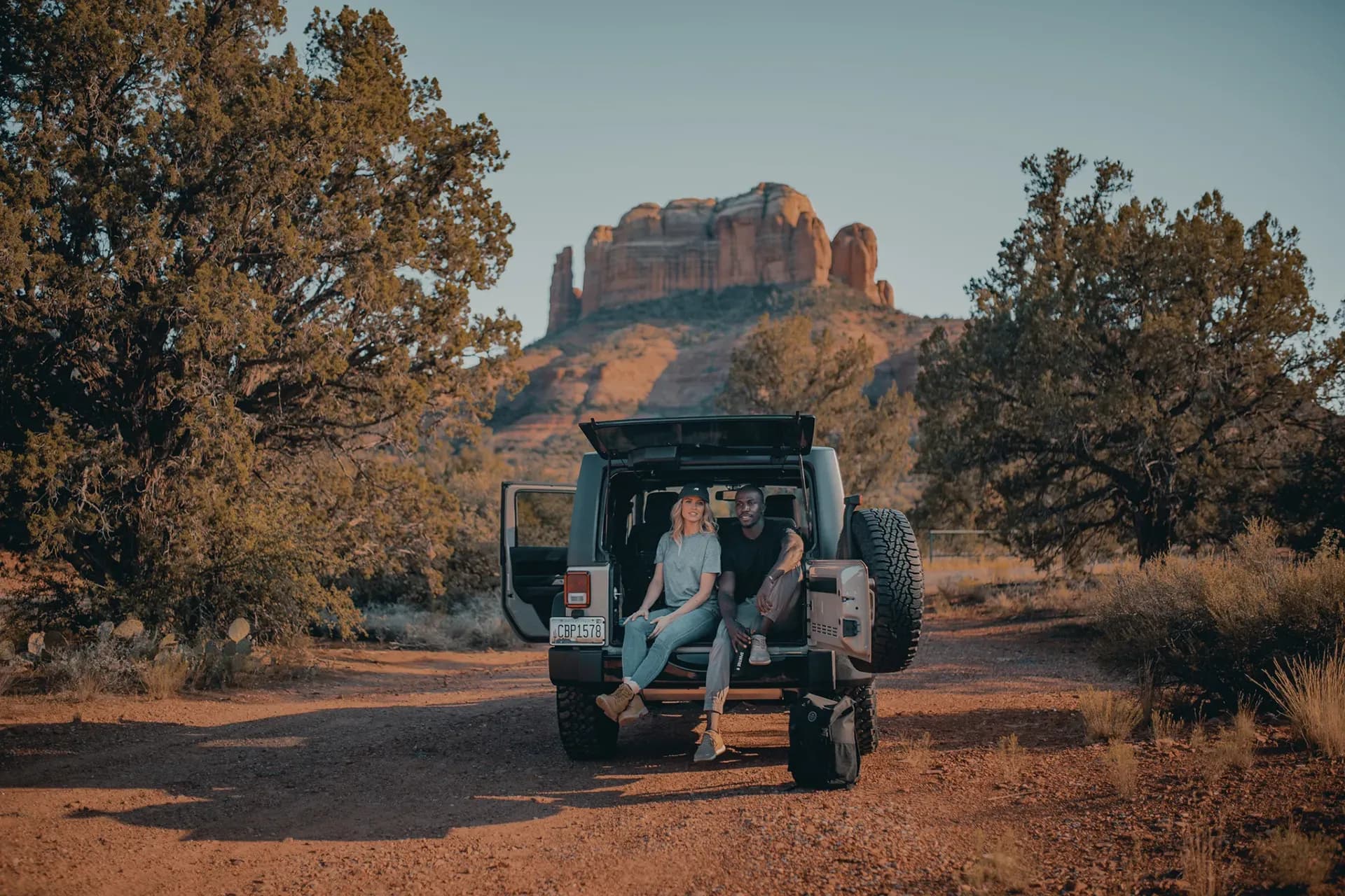 Couple in a jeep among the red rocks
